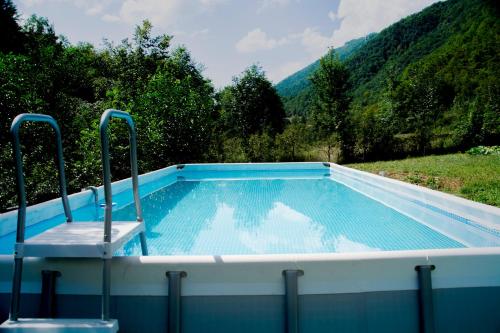 a swimming pool with two chairs sitting in it at Holiday home "Aida" in Visoko