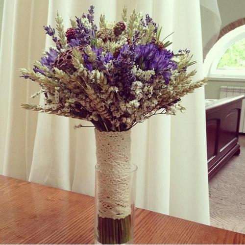 a vase filled with purple flowers on a table at Villa Oselya in Kyiv