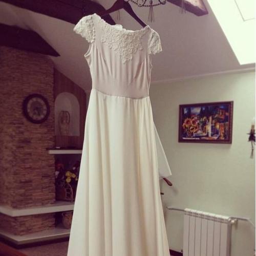 a white wedding dress hanging from a ceiling at Villa Oselya in Kyiv