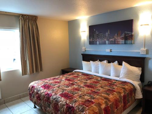 a hotel room with a bed and a window at Midtown Inn in Springfield