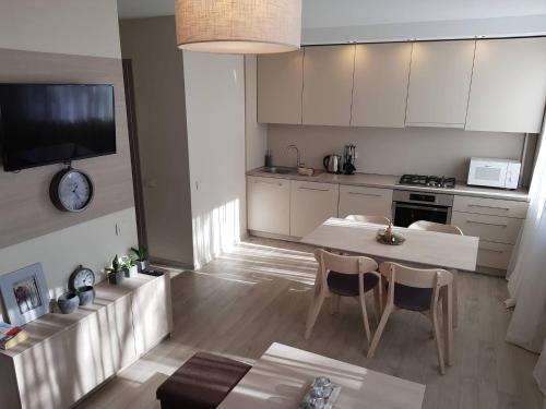 eine Küche mit einem Tisch und Stühlen im Zimmer in der Unterkunft Apartamentai Vilniaus Street in Šiauliai