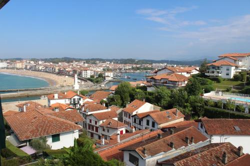 a view of a town with houses and a beach at Hotel Agur Deneri in Ciboure