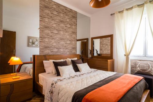 a bedroom with a bed and a brick wall at Dream city home 2 in Caldas da Rainha