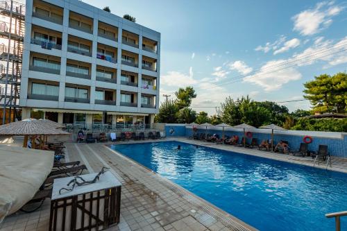 a large swimming pool in front of a building at Dolphin Resort & Conference in Kalamos