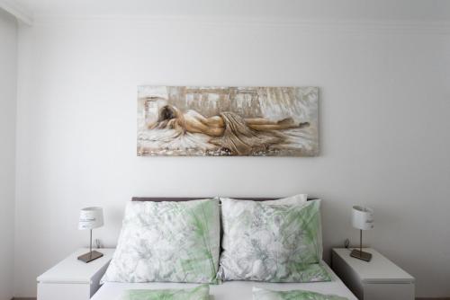 a bedroom with a bed with two night stands at Let it be Vienna U1, U2, U4 Karlsplatz Oper in Vienna
