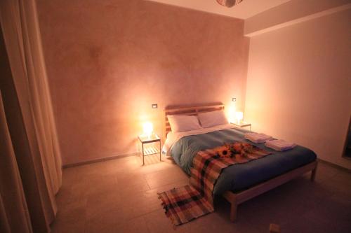 a bedroom with a bed with two lights on it at Il Rifugio degli Artisti in Varese