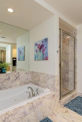 a large bathroom with a tub and a shower at Sapphire in South Padre Island