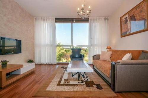 a living room with a couch and a table at Caesarea Vacation Rooms in Caesarea