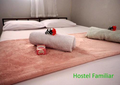 a bed with two towels on top of it at Pousada Ambiente Familiar in Ponte Alta do Tocantins