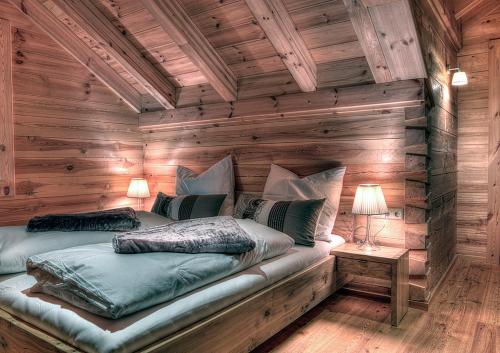 a bedroom with two beds in a log cabin at Chalet4You in Haus im Ennstal