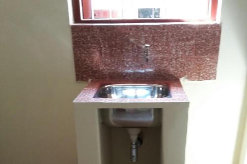 a bathroom with a sink and a window at J & B Holiday Homes in Benaulim