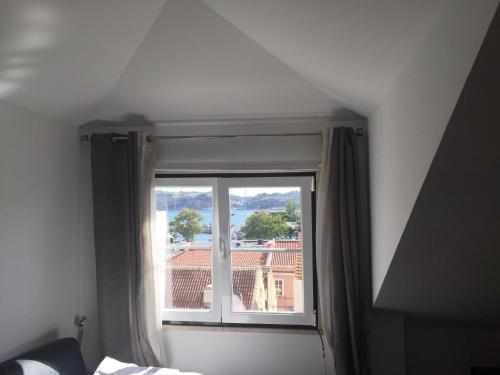 a bedroom window with a view of a building at Belen Center Riverview in Lisbon