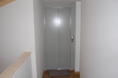 a hallway with a white door in a room at Haus Steuerrad in Stralsund