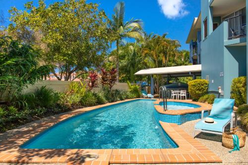 a swimming pool in the backyard of a house at Twin Quays Noosa in Noosaville