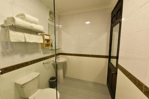a bathroom with a toilet and a shower with towels at Hanoi Marriotte Hotel in Hanoi