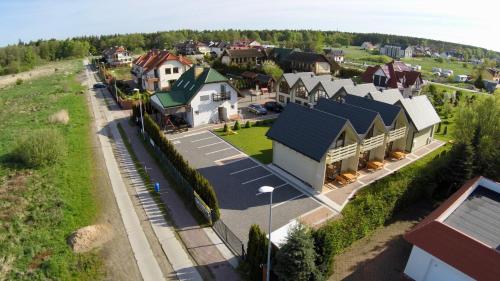 an aerial view of a small town with houses at Domki Gala - blisko plaży i centrum in Grzybowo