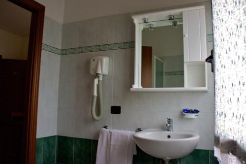 a bathroom with a sink and a mirror at Hotel Ristorante Gallo D'Oro in Vignola