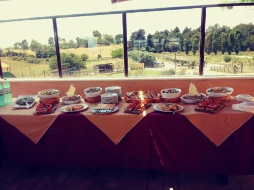 a table with bowls and plates of food on it at Il Casale Di Roma in Prima Porta