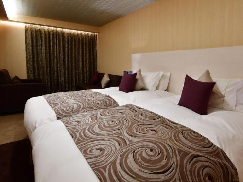 Tempat tidur dalam kamar di Centurion Hotel Classic Nara Station