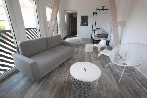 a living room with a couch and a table and chairs at Subtil insolite in Colmar