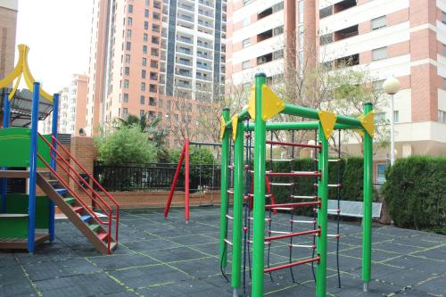 a playground with colorful play equipment in a city at Oceanográfico Apartments in Valencia
