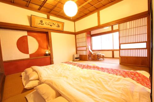 um quarto com uma cama grande num quarto em Fuji Sakura House em Fujikawaguchiko