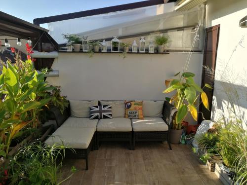 a small patio with a couch and some plants at Floorplan B - 208 in Turin