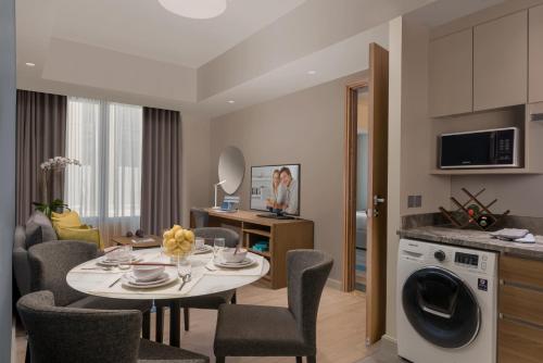 a kitchen and living room with a table and chairs at Citadines Bay City Manila in Manila