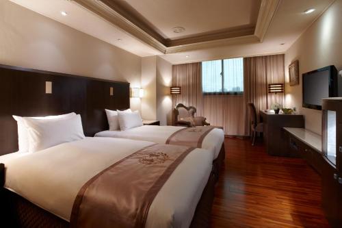 Tempat tidur dalam kamar di Taipei Charming City Hotel