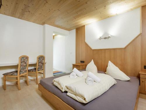 a bedroom with a bed and a table and chairs at Apart Gentiana in Sölden