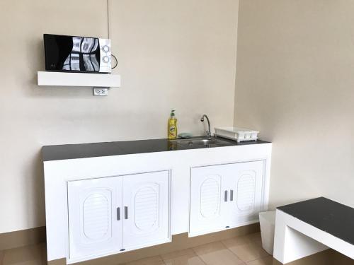 a kitchen with a sink and a white cabinet at Tk Home 3 in Lampang