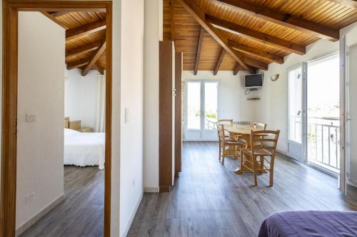 een kamer met een tafel en stoelen en een slaapkamer bij Terrasse de Malbeccu in Casamaccioli