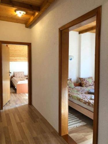 a room with a bedroom with a bed and a mirror at Apartment Suzana in Mavrovo