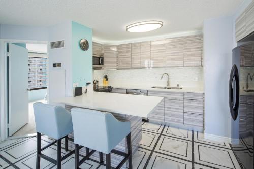 a kitchen with a white island and blue cabinets at Waikiki Timeshare 77 in Honolulu