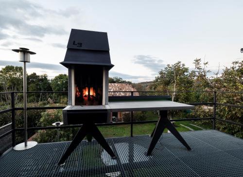 a table with a fireplace on top of a balcony at DVOR 13 Hokovce in Hokovce
