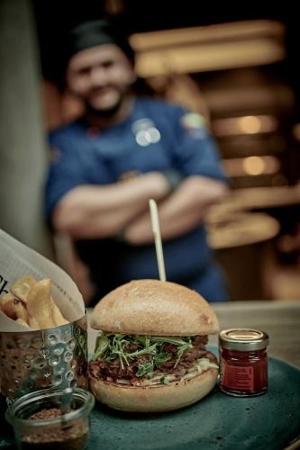 a sandwich and chips on a table with a police officer at Genusshotel Wenisch in Straubing