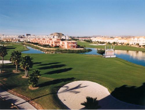 an aerial view of a golf course at a resort at Apartamento en 1ª línea con piscina in Alicante