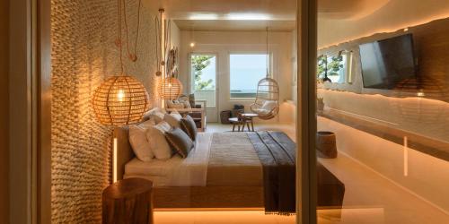 a bedroom with a bed and a television in a room at Divelia East in Imerovigli
