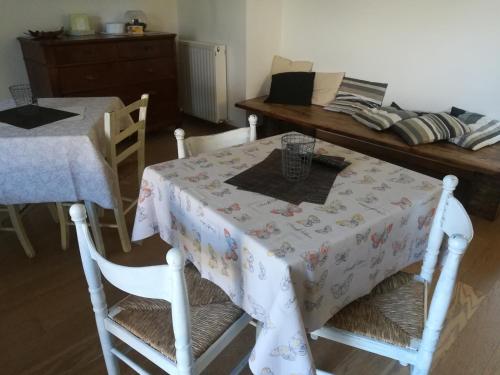 una mesa con un mantel blanco con dos sillas en Agriturismo "La di Buiat, en Cividale del Friuli