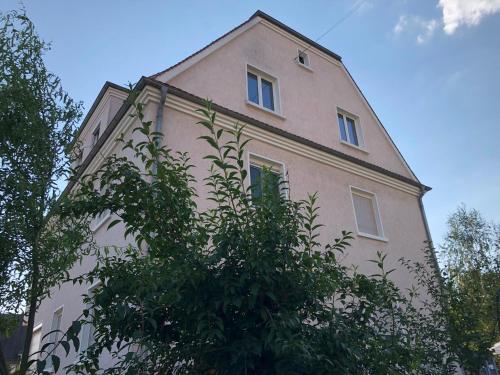 a building with a tree in front of it at Schöne‘s Eck in Großröhrsdorf