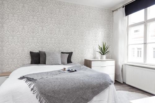 a bedroom with a bed and a wall at Central Alexandra in Tampere