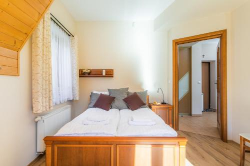 a bedroom with a wooden bed with white sheets at Rent like home - Krzeptówki in Zakopane