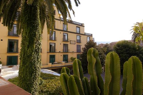 a group of cactuses in front of a building at Hotel Eden in Sorrento