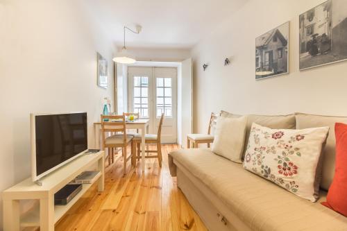 - un salon avec un canapé et une télévision dans l'établissement Guest Inn Alfama, Premium Apartments, à Lisbonne