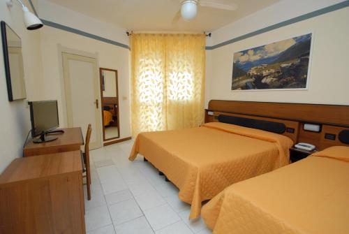 Postel nebo postele na pokoji v ubytování Hotel Baia Del Sorriso