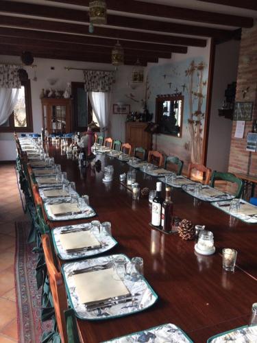 a long table with plates and dishes on it at Country House Salomè in Musile di Piave