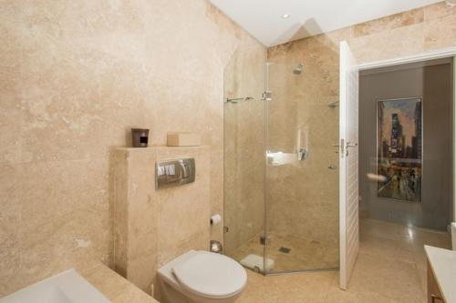 a bathroom with a toilet and a glass shower at Zimbali Luxury 3 Bedroom Villa KB01 in Ballito