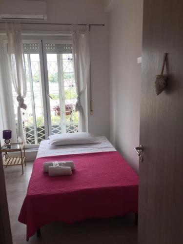 a bedroom with a bed with a red blanket at Affittacamere Roma Tiburtina in Rome