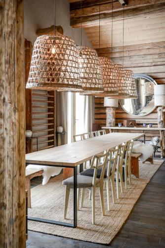 a dining room with a large wooden table and chairs at Chalet Nantailly in Hauteluce