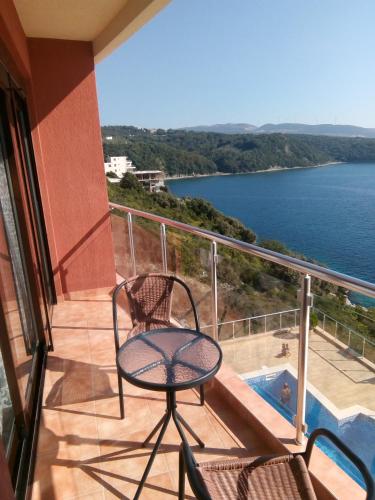 a balcony with a chair and a view of the water at Apartment Sea Space in Dobra Voda